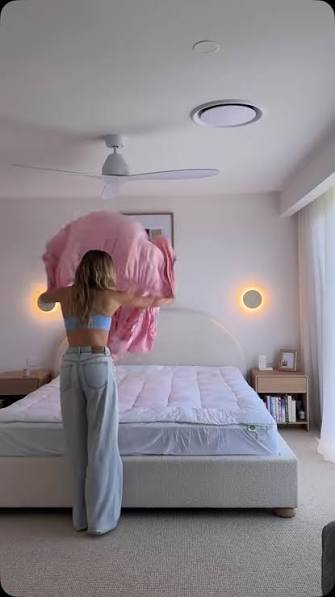 teen girl making her own bed